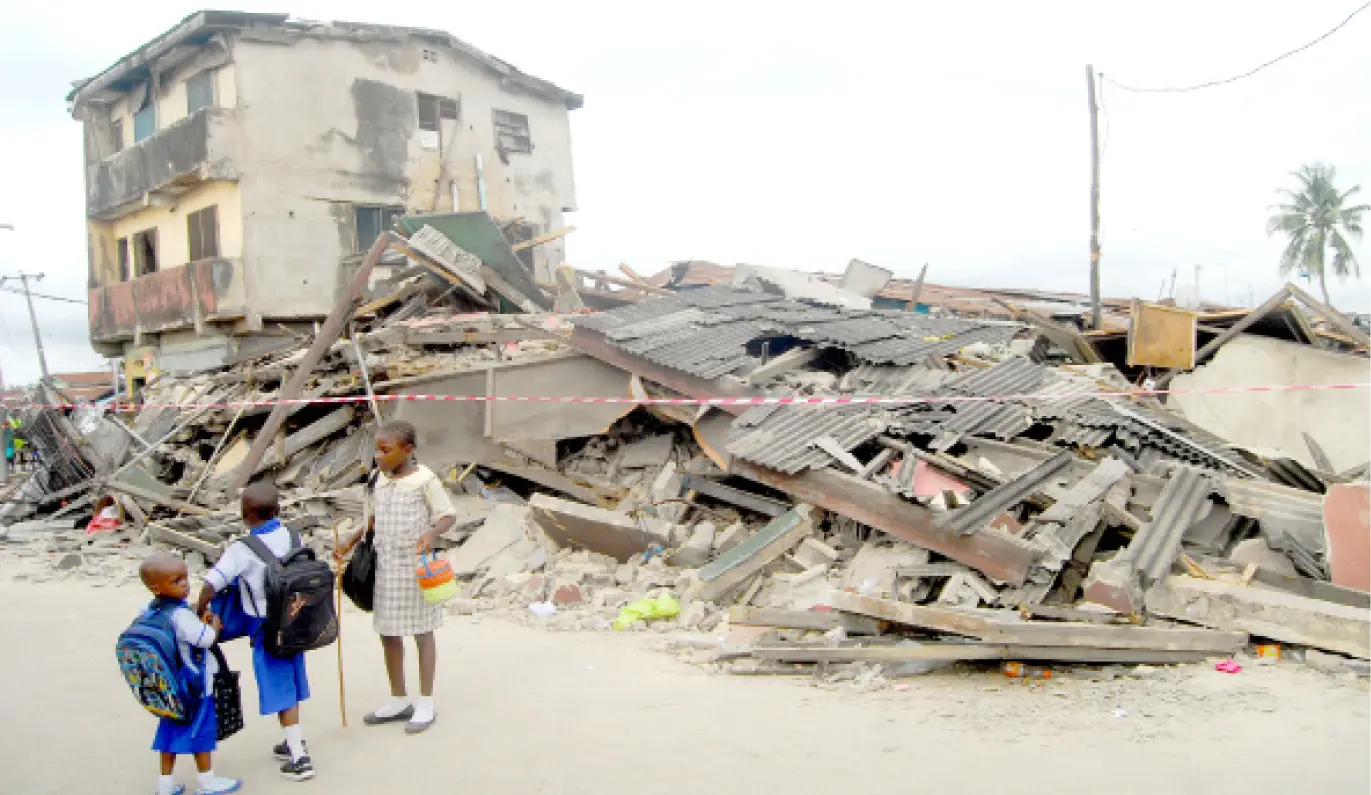 Children walking past a collapsed building along Amusu Street, Sari Iganmu, Lagos.