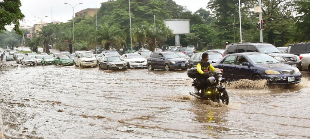 A flooded street with cars partially submerged, illustrating the potential impact of heavy rainfall.