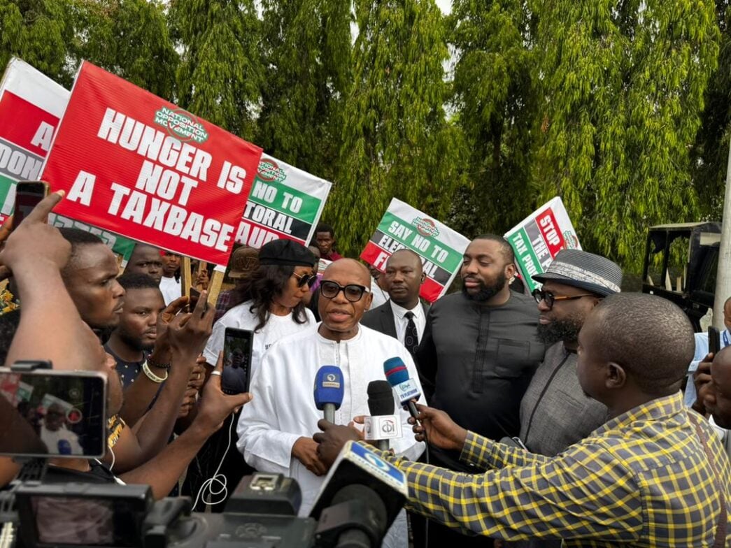 Rotimi Amaechi participating in the protest at the National Assembly with his son