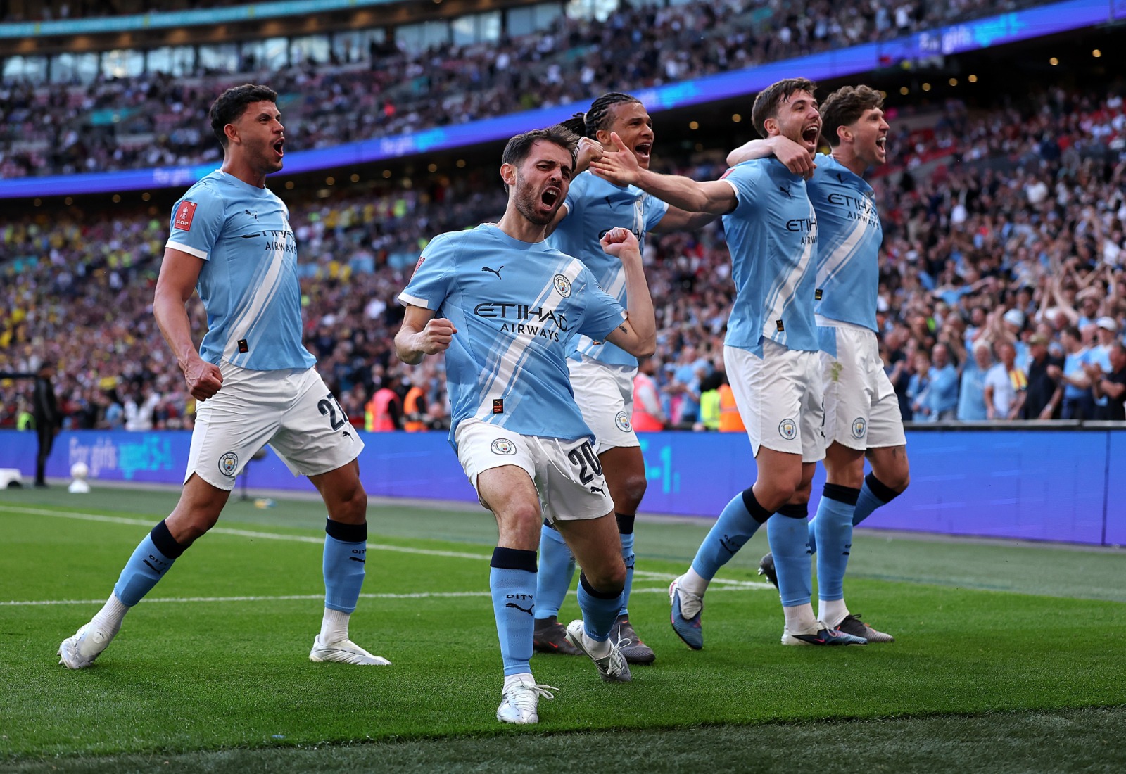 Manchester City players celebrating a goal during the FA Cup semi-final match.