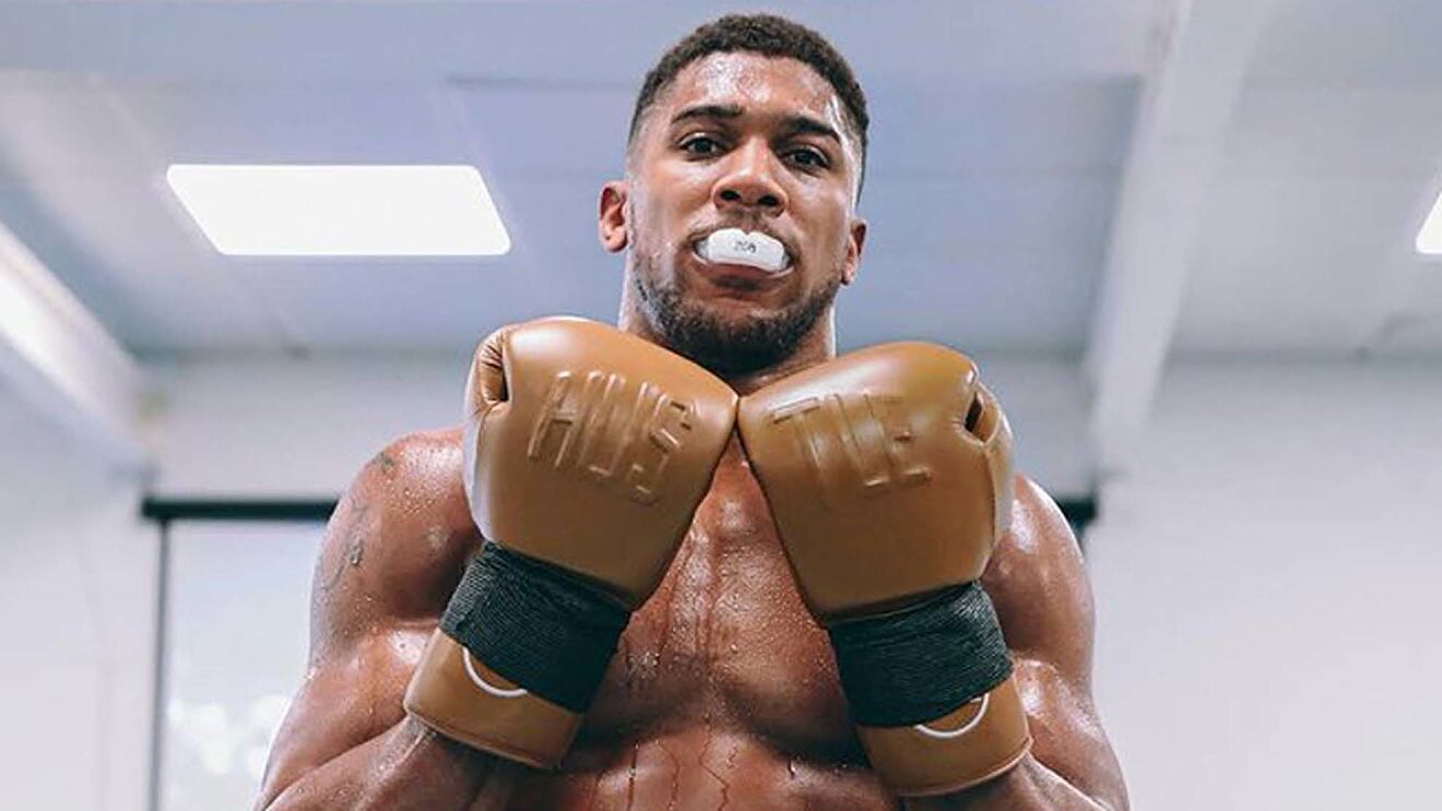 Anthony Joshua in boxing attire posing confidently