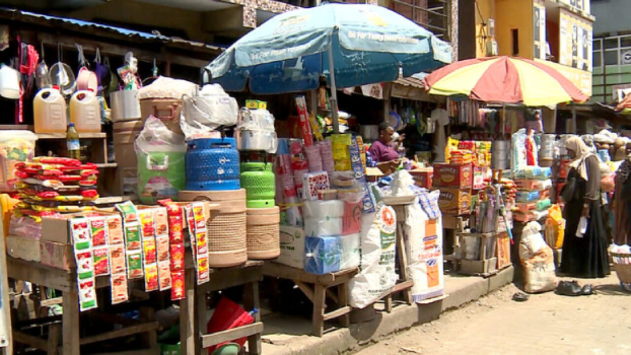 Market scene showing various food items for sale.