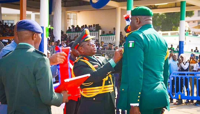 President Julius Maada Bio of Sierra Leone presenting honors to Nigerian military officers