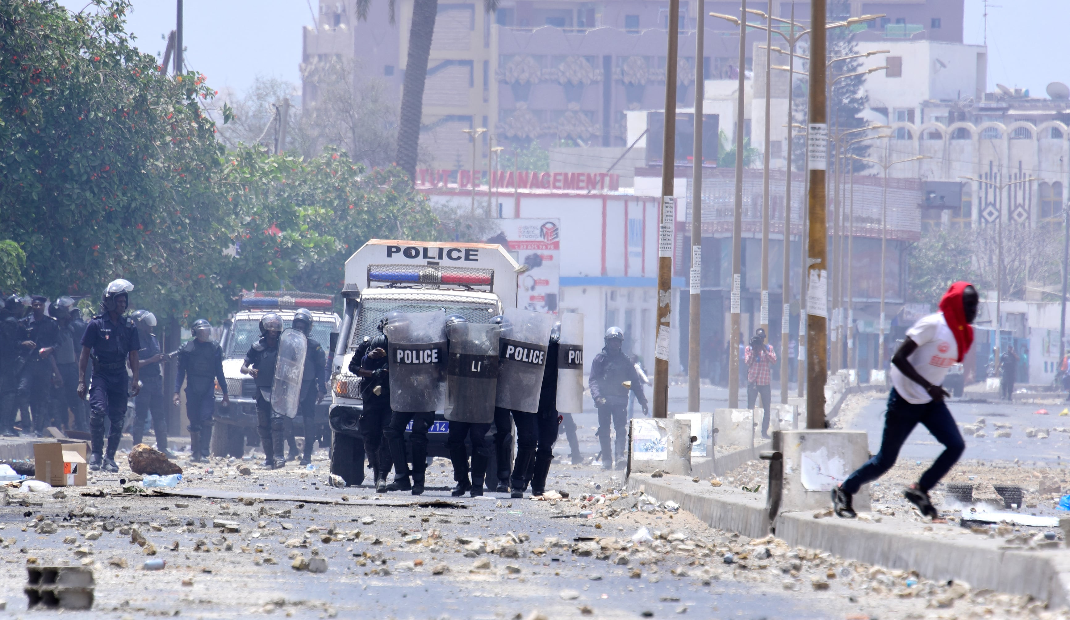 A view of a Dakar university campus engulfed in protest-related flames and smoke.