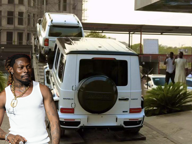 Afrobeats star Asake posing with his new Brabus G800 vehicle.