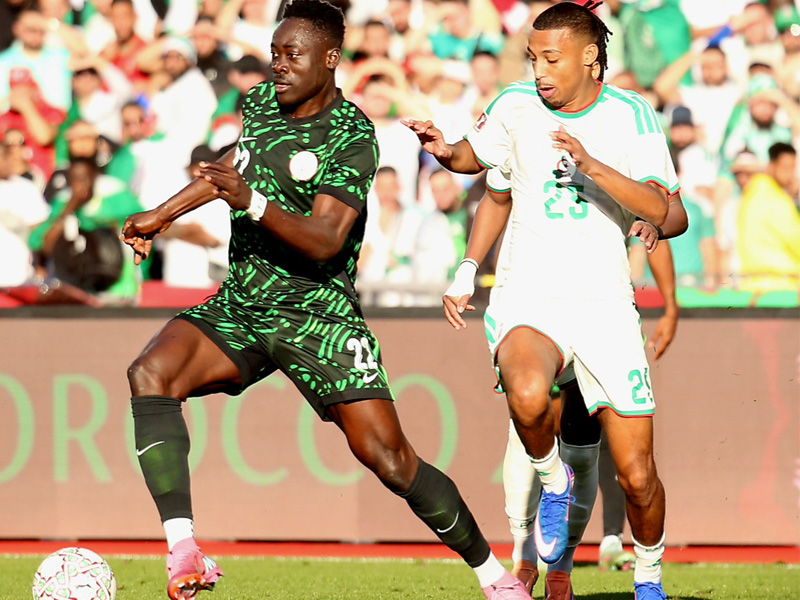 Super Eagles players Wilfred Ndidi and Alex Iwobi in action.