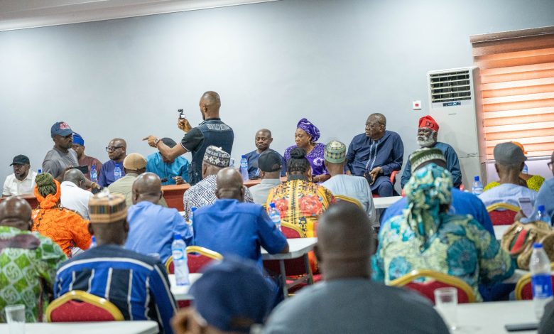 A group of people gathered, possibly at a political meeting or conference.