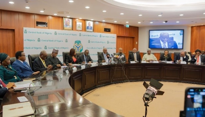 Nigerian currency notes and coins representing bank deposits at the Central Bank of Nigeria.