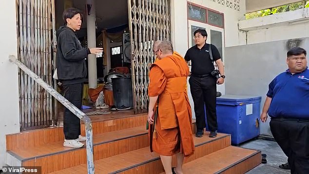 Officers arresting the monks at the temple premises