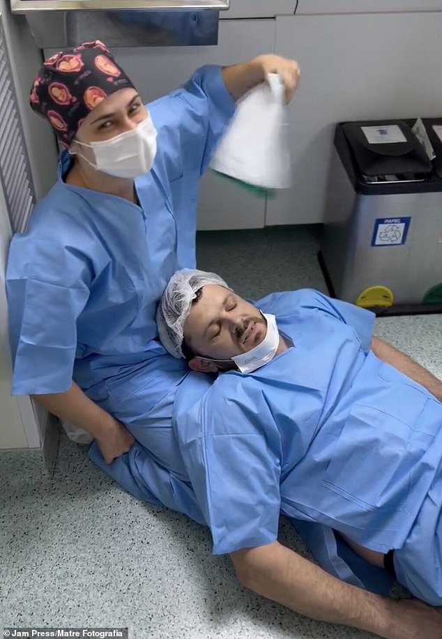 A father is being helped by medical personnel after fainting.