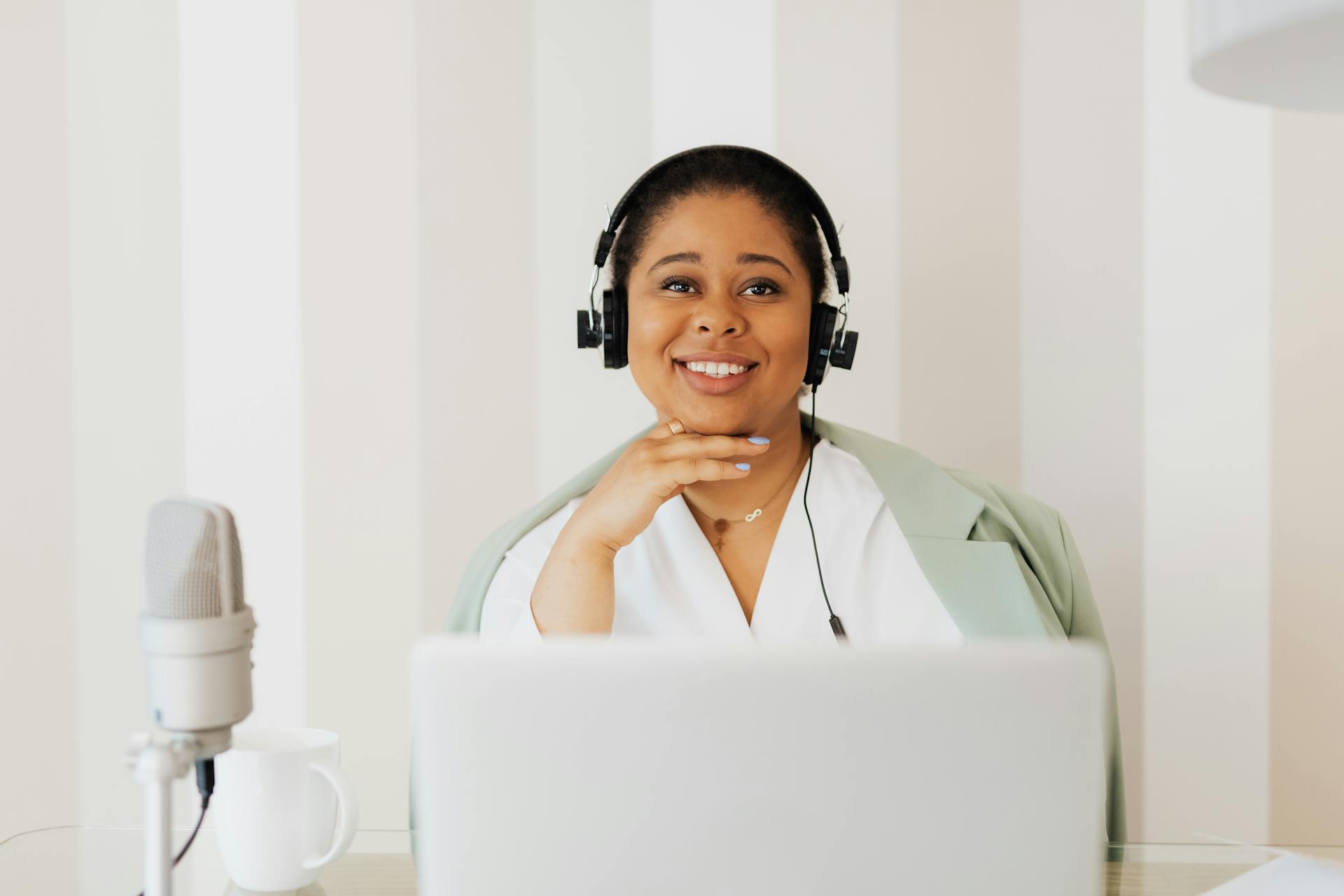 A woman looking thoughtfully out a window, symbolizing introspection and potential.