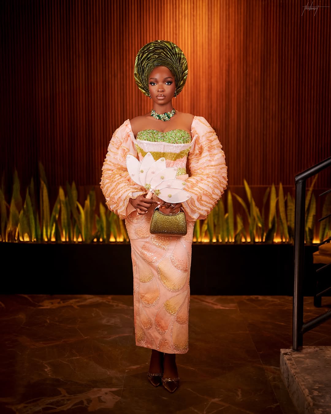 Full shot of a Yoruba bride in a peach traditional wedding attire