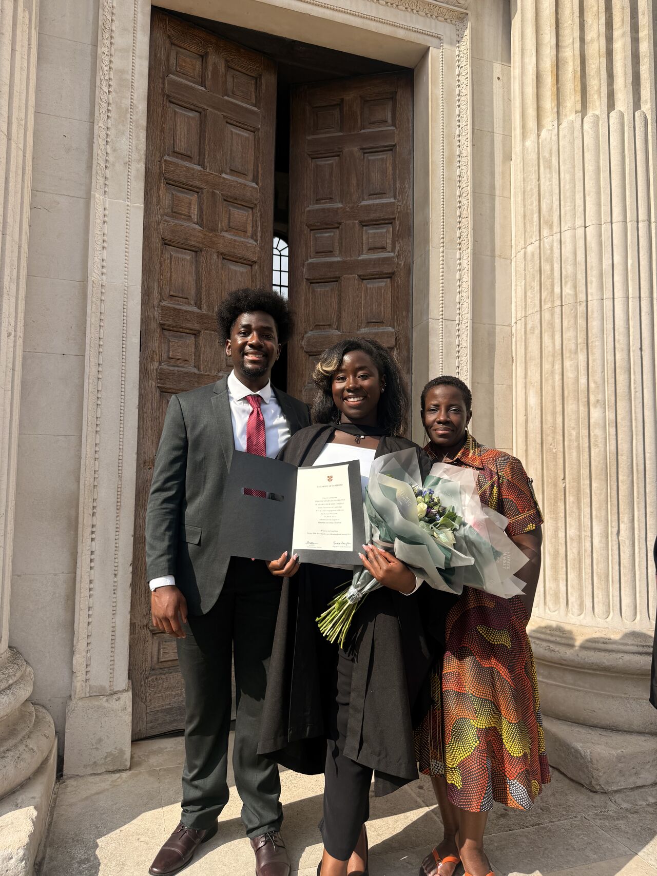 Gates Cambridge Scholar Ifeanyi Ruth Umunna celebrating her MPhil in Criminology degree from the University of Cambridge with her mother, Professor Dehlia Umunna, and brother Edozie Umunna.