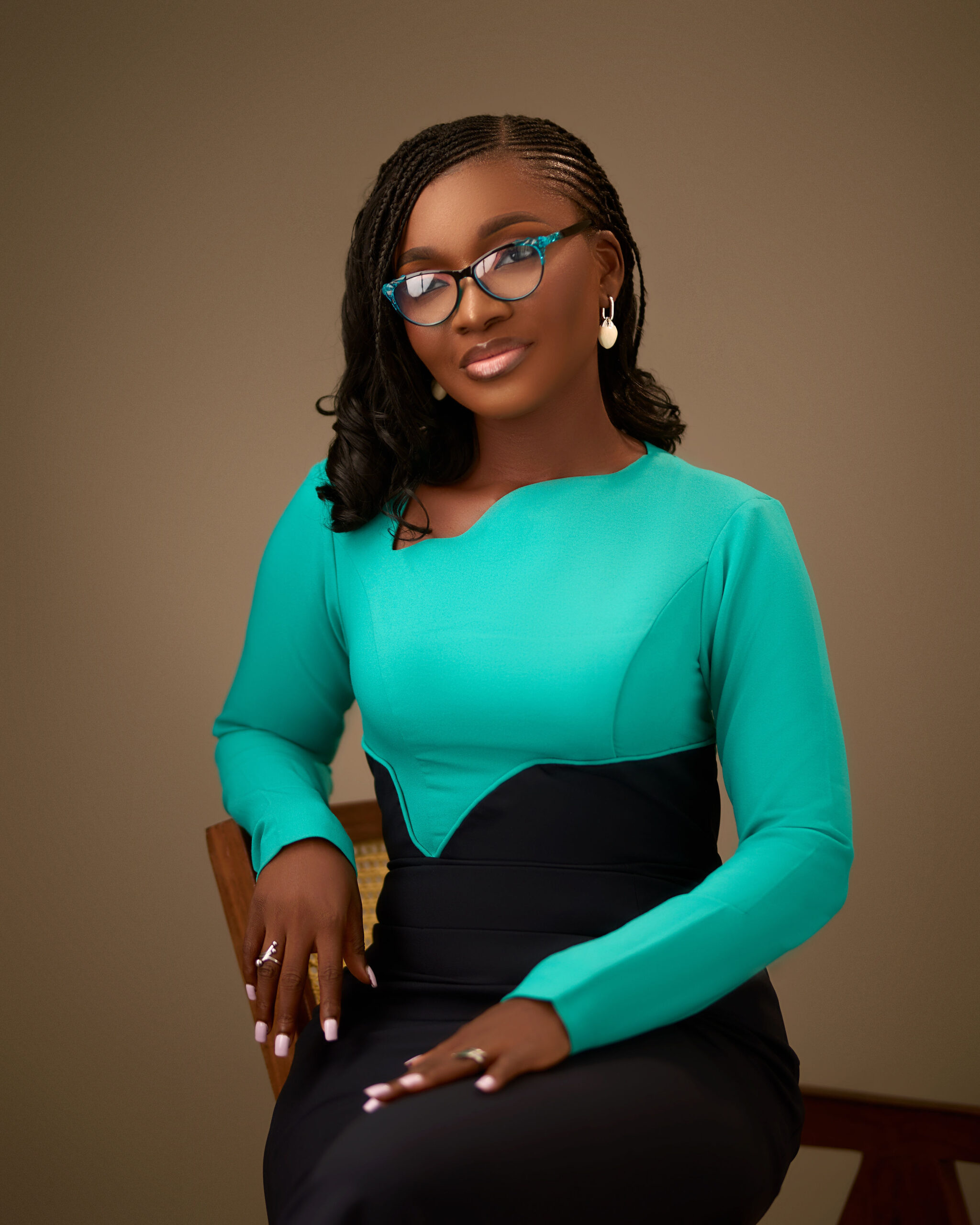Modupeola Akinyemi smiling at the camera in a studio setting.