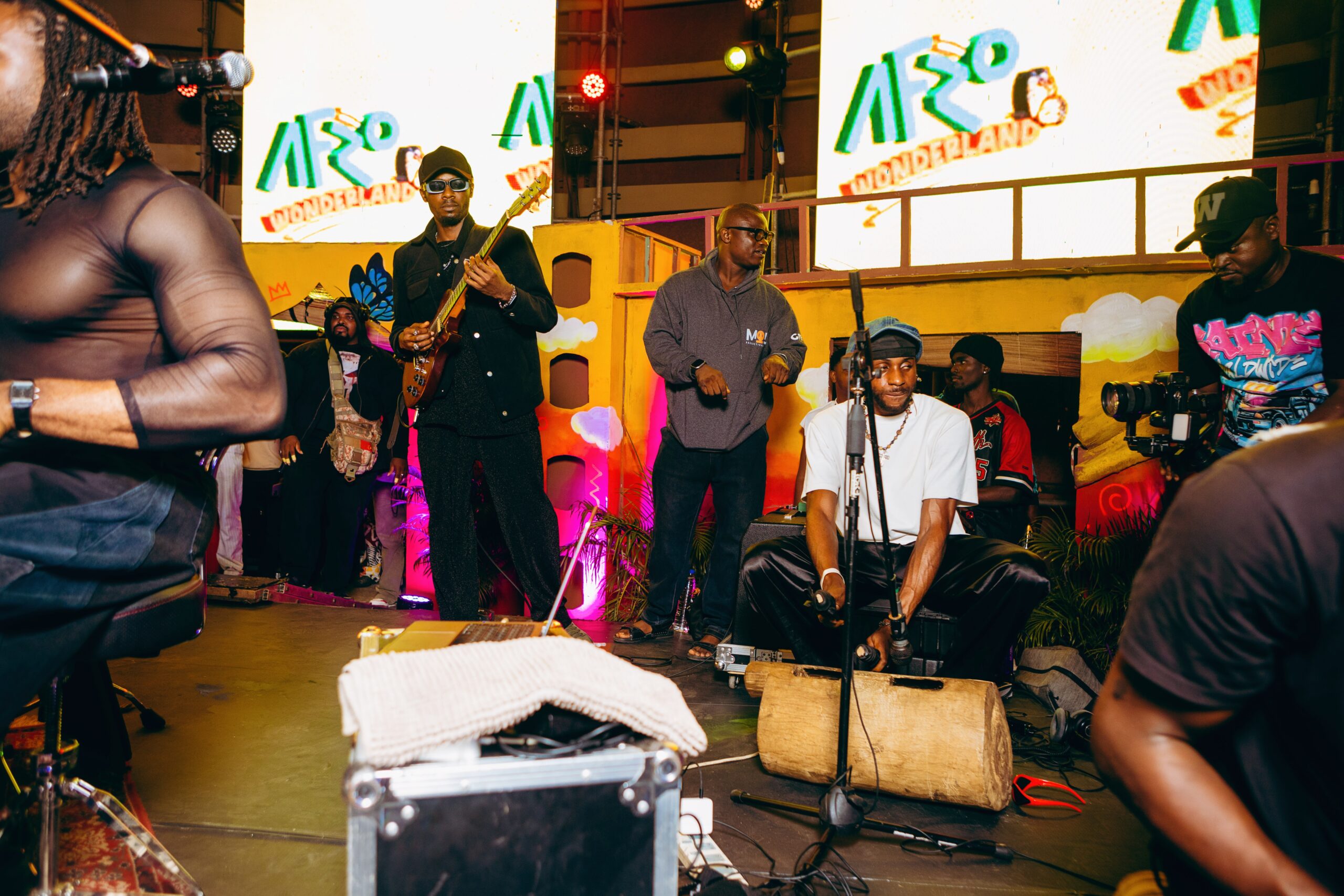 Attendees are shown enjoying the music and ambiance during the Afro Wonderland event.