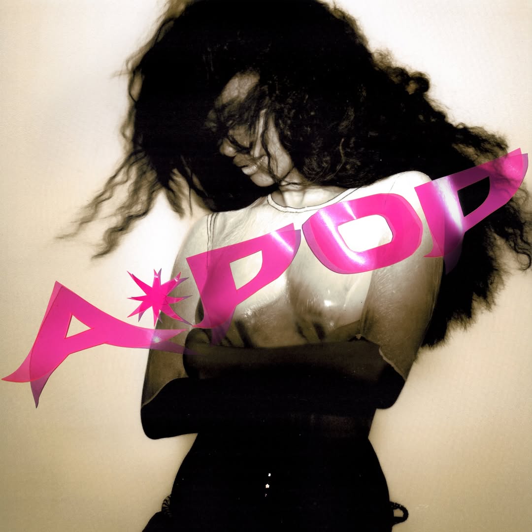 A grainy, high-contrast black-and-white portrait of Tyla with voluminous hair covering her face, overlaid with a bold pink "A*POP" graphic.