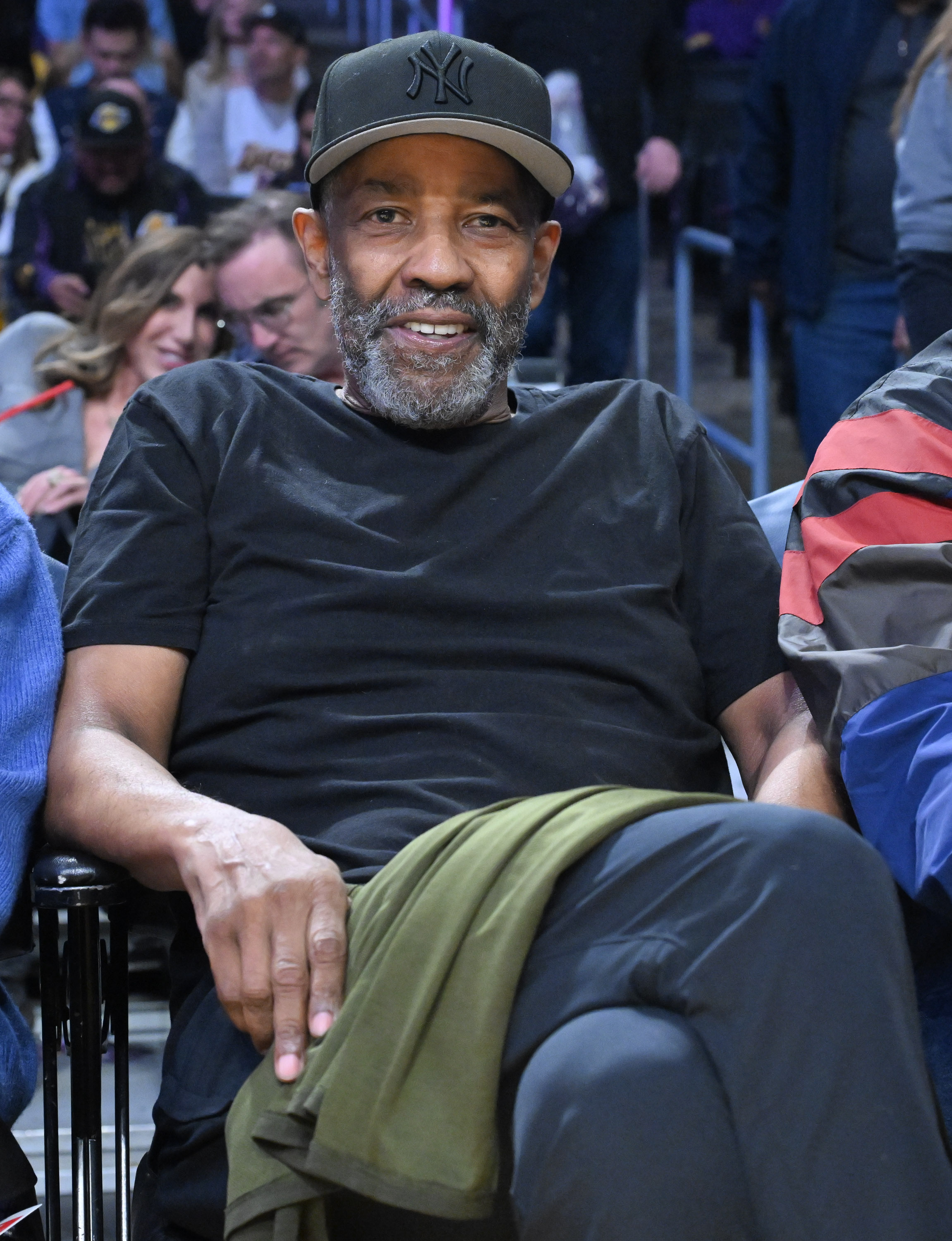 Denzel Washington at the 76ers vs Lakers game, sitting courtside and looking trimmer