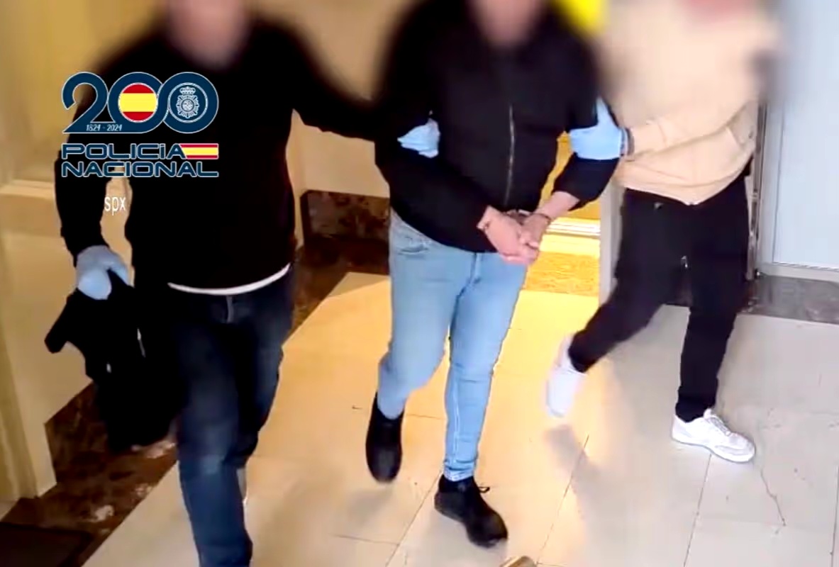 Suspect being led away by police in Madrid following his arrest for livestreaming abuse.
