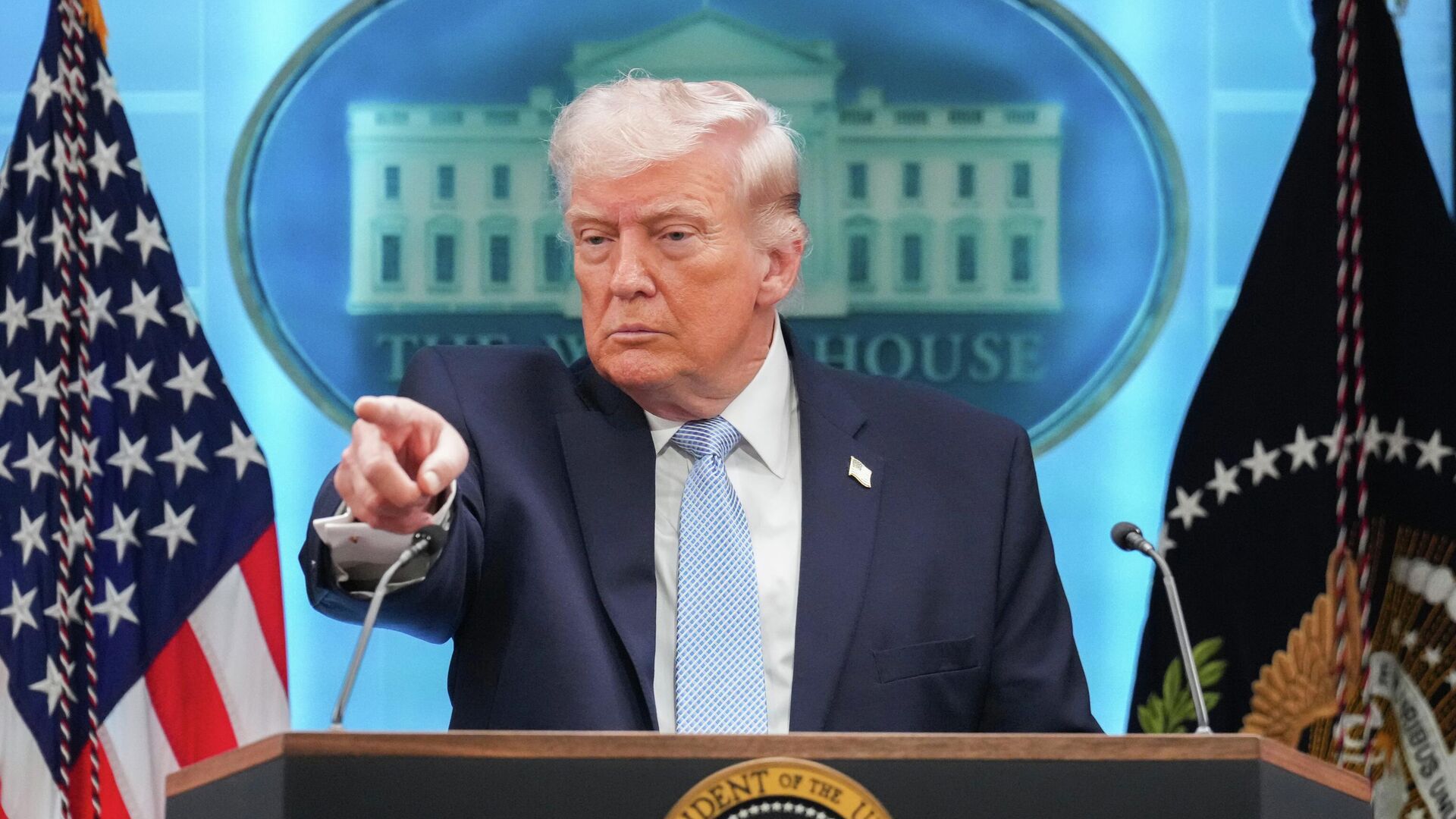 Donald Trump speaking at a podium.