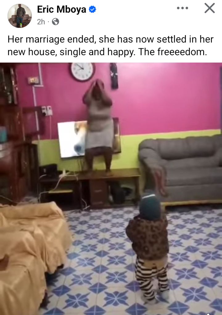 A Kenyan woman joyously dances in her new living room after moving in.