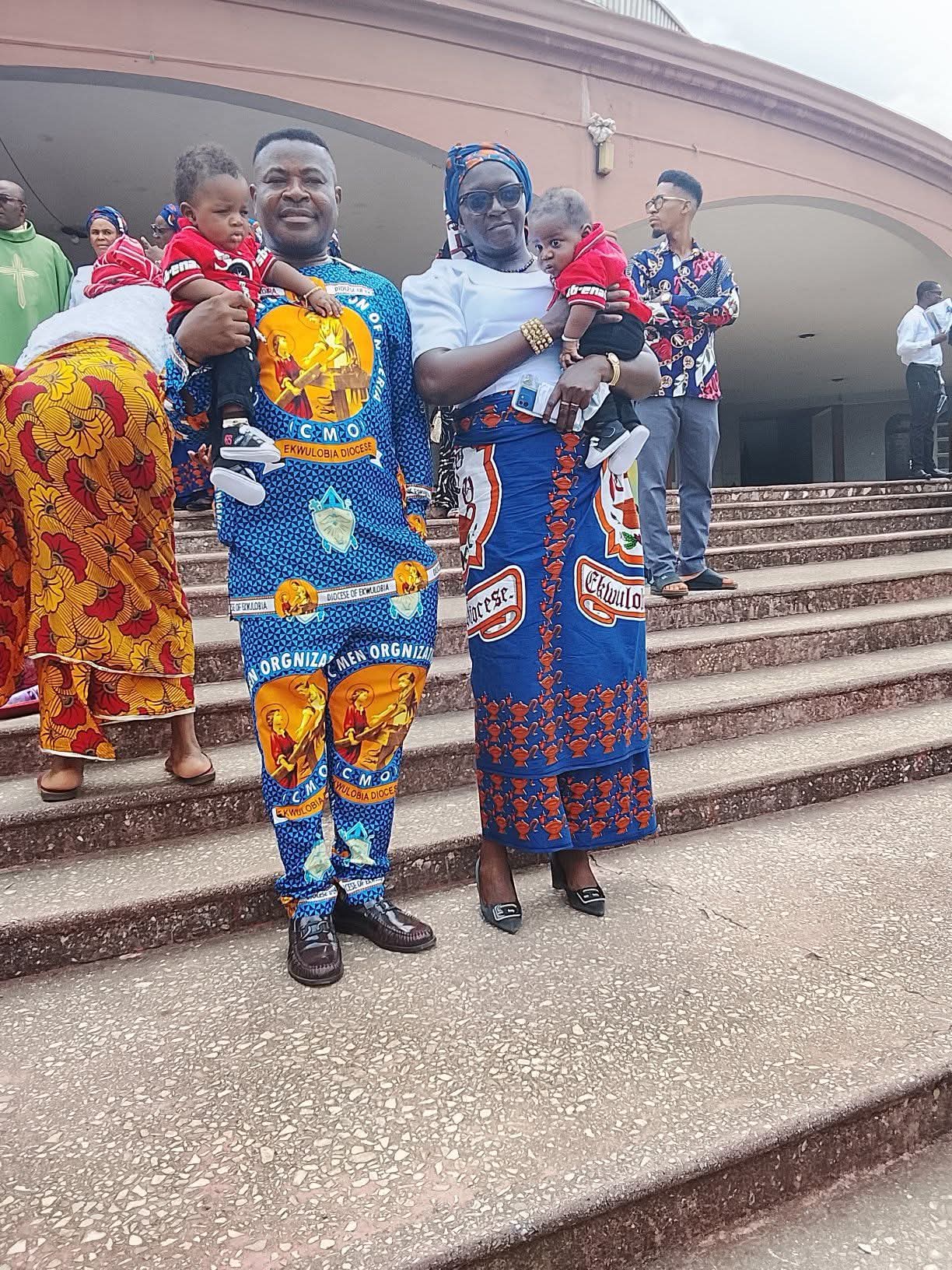 Nigerian father with his daughters and new twin boys during the church dedication