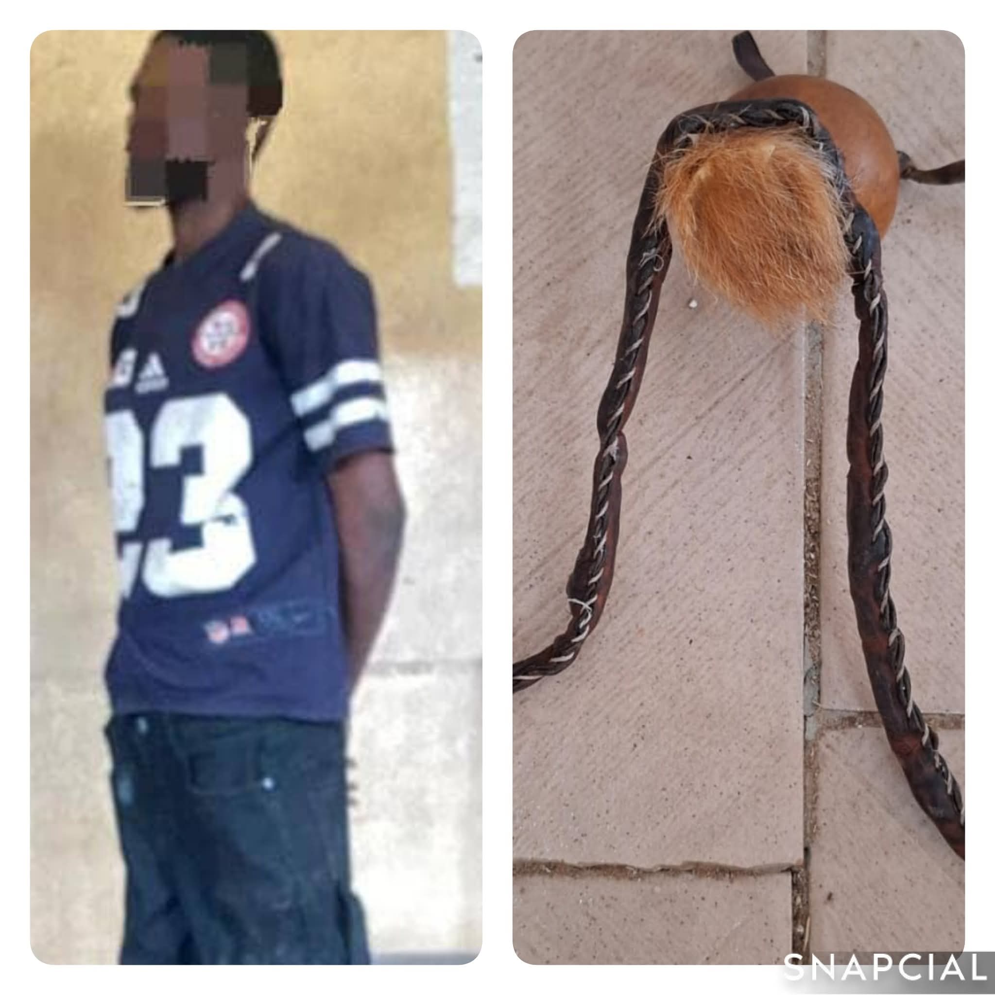 Police officer arresting Akinwale Tomiwa, the notorious cult leader.