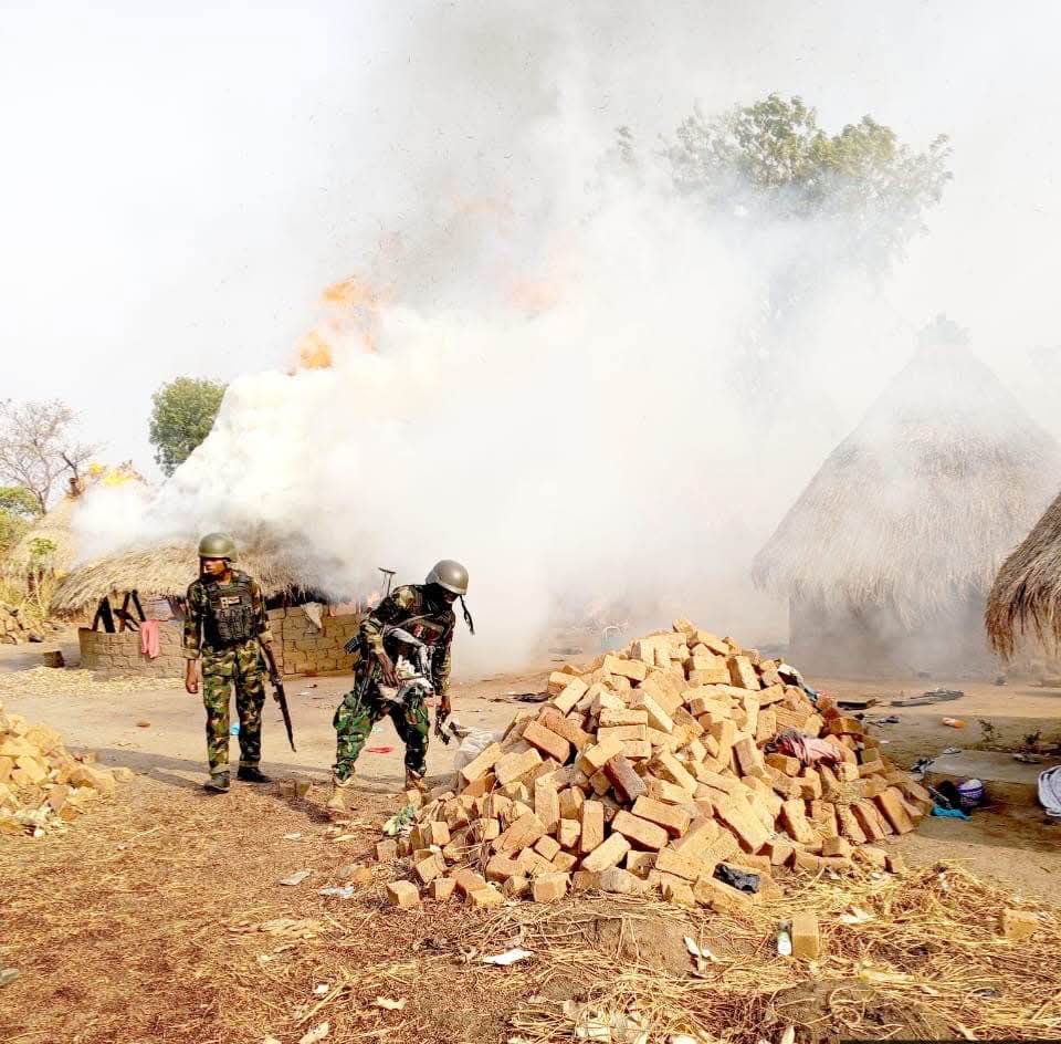 Troops recovering arms and gear left behind by bandits.
