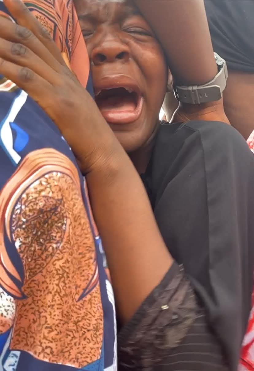 A young girl weeping at a burial site, believed to be during the funeral of her father killed in the Plateau attack.