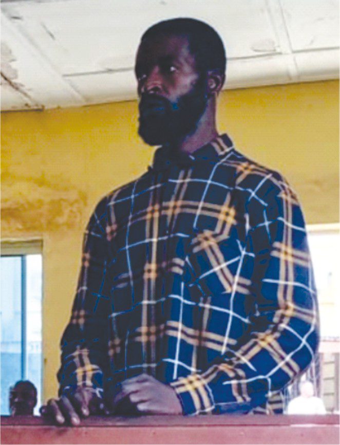 A man, identified as Suleiman Adams, stands in a courtroom.