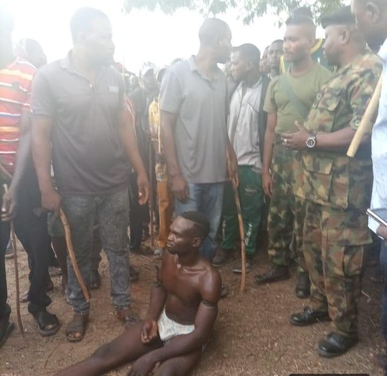 Suspected kidnapper being rescued by troops.