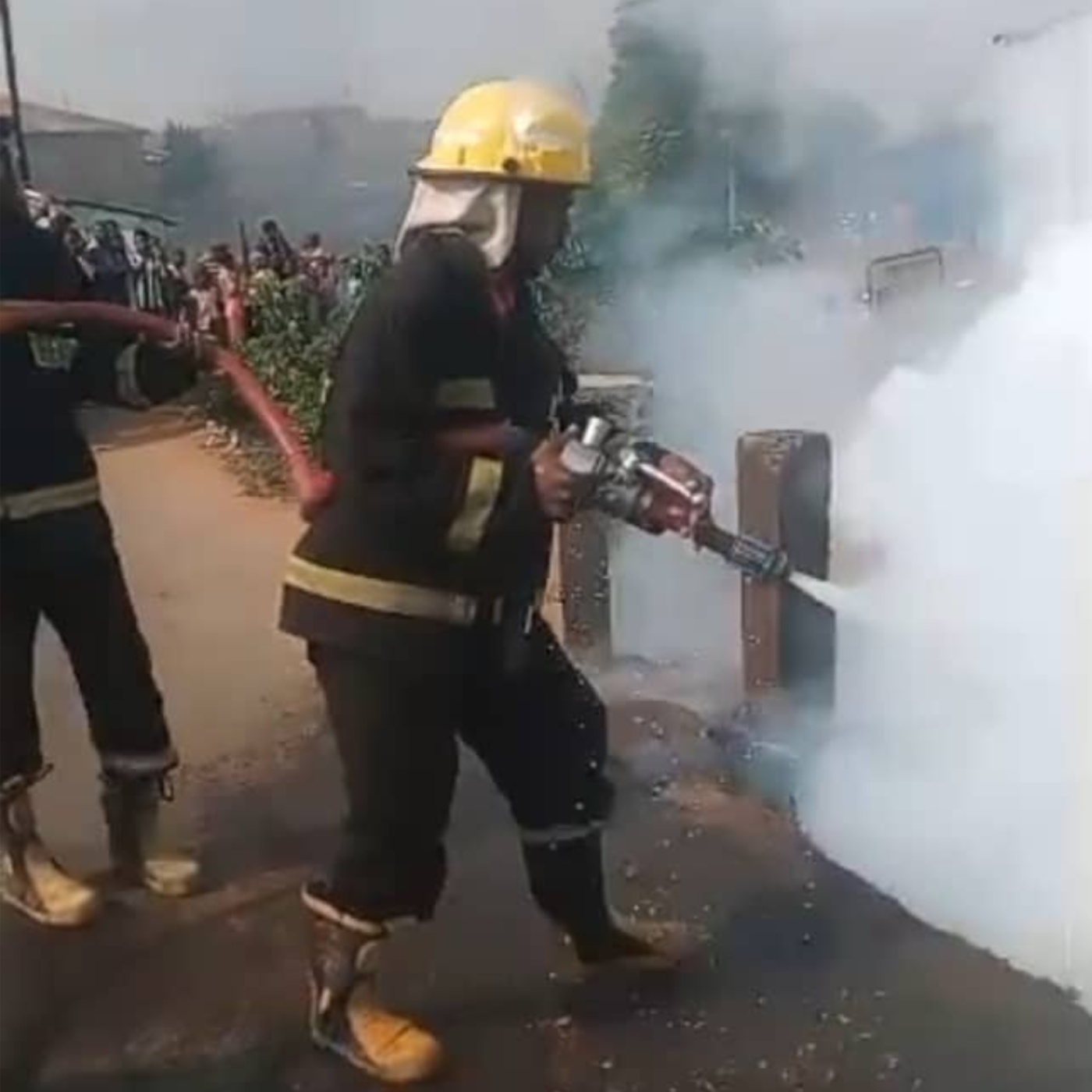 Firefighters at the scene of the vehicle fire in Ibadan