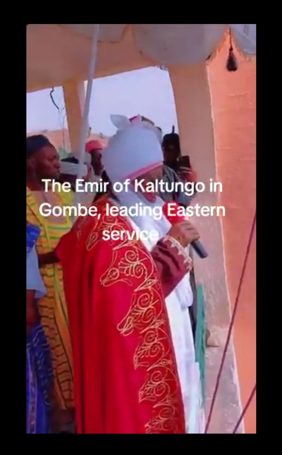 Screenshot showing the Emir of Kaltungo participating in a Christian hymn.