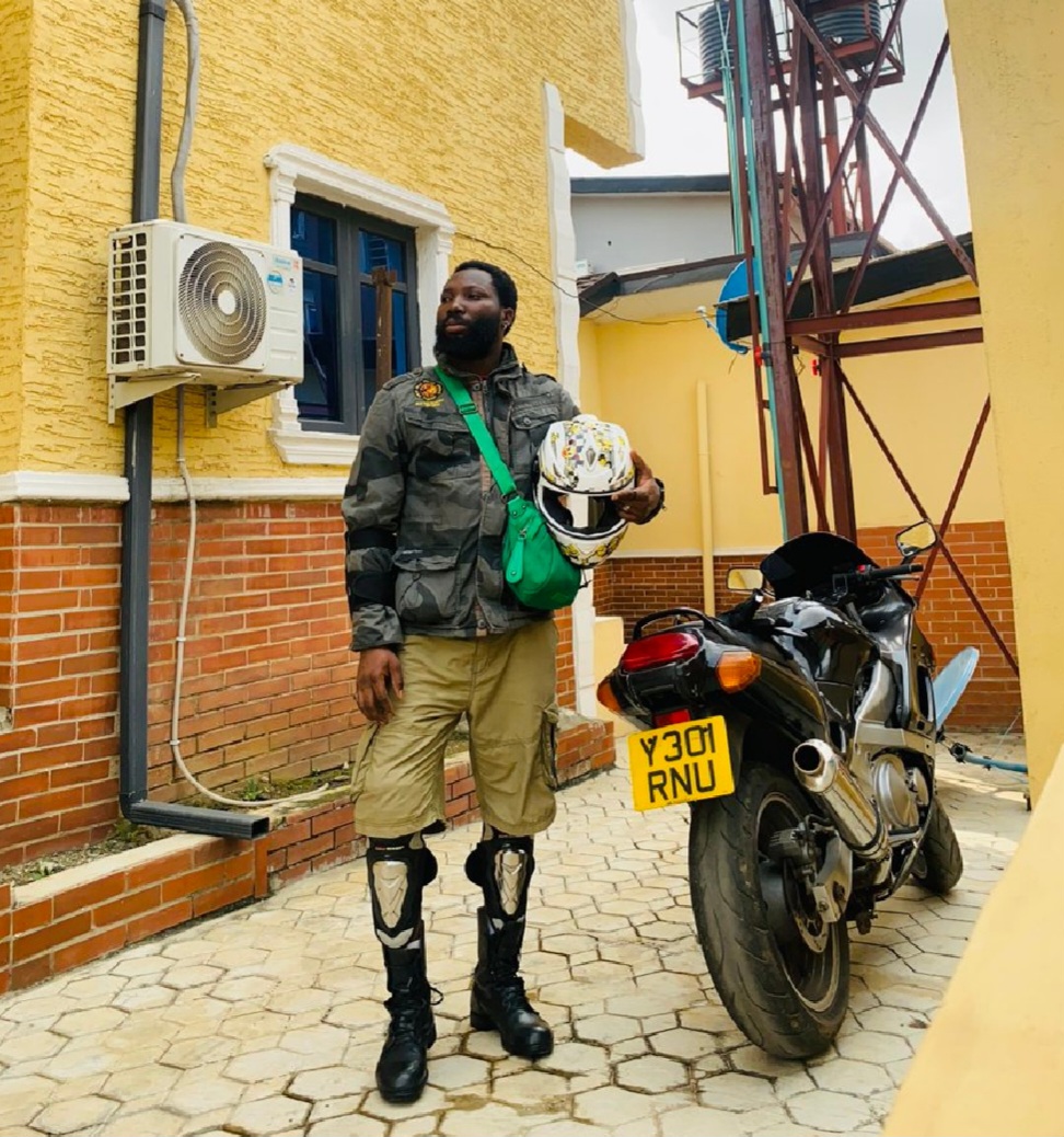 Kola Onifoto posing with his motorcycle