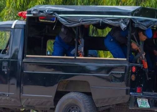 Police officers at the scene where suspects were arrested in connection with robbery.