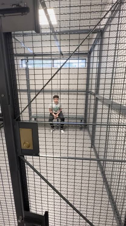 Photo of the boy during a police escort following his arrest.