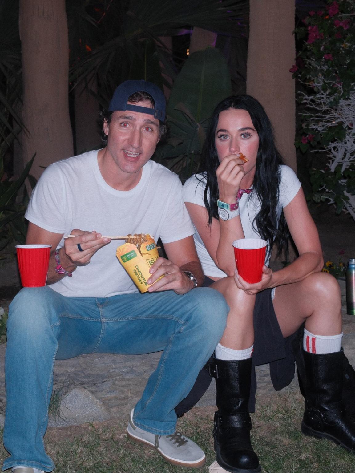 Justin Trudeau and Katy Perry at an event, with Trudeau holding a red plastic cup.